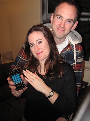 Patrick Long, 37, and his fiancee, Jennifer Longman, holding the custom version of the game Wordament that he created to propose to her last month.