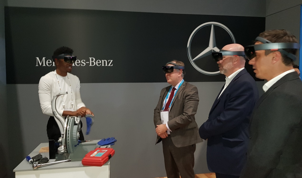 Four people standing, wearing Microsoft HoloLens