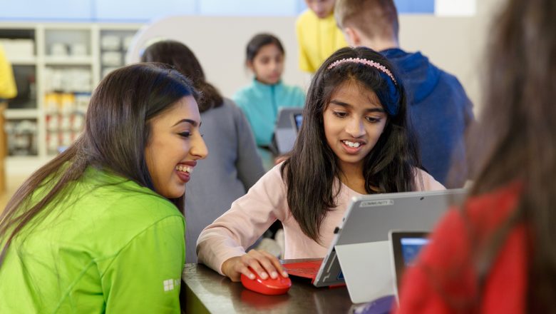 Two kids looking at a Windows 10 device