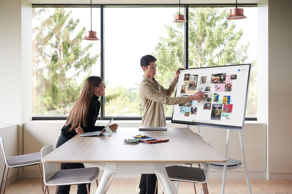 Workers using Surface Hub 2 to collaborate