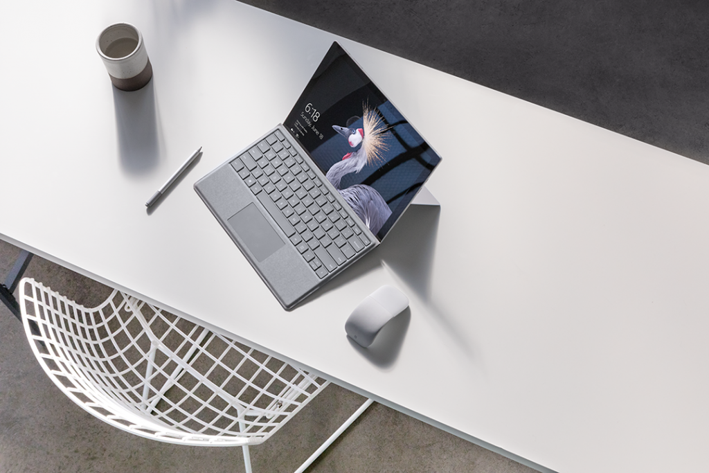 Surface Pro sitting on a white desk.