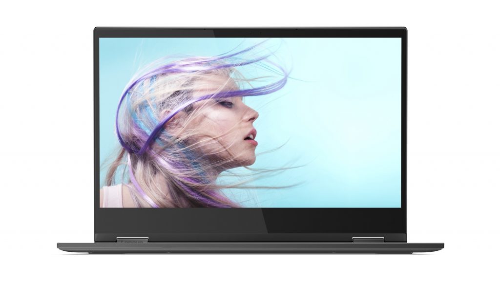 Lenovo Yoga C630 open with the screen facing the viewer with a woman with blue, blonde and purple windswept hair on the screen