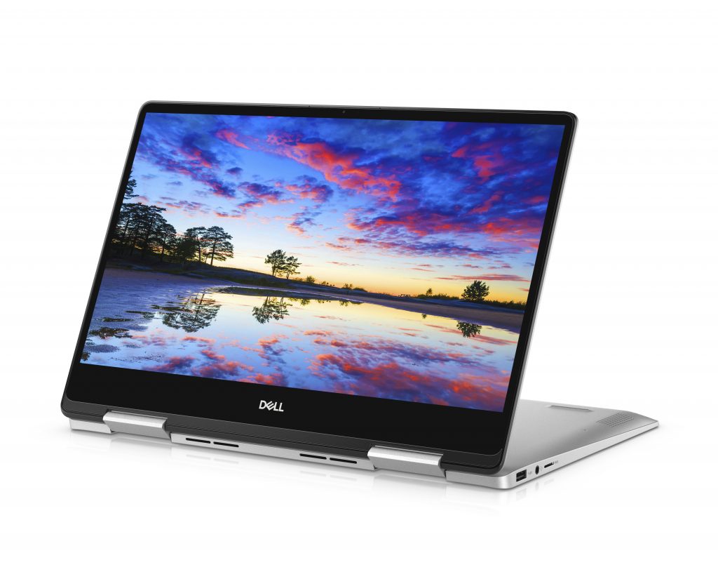 Dell Inspiron 13 7000 2-in-1, open, sitting on its hinge with one screen flat, the other one showing dusk over water