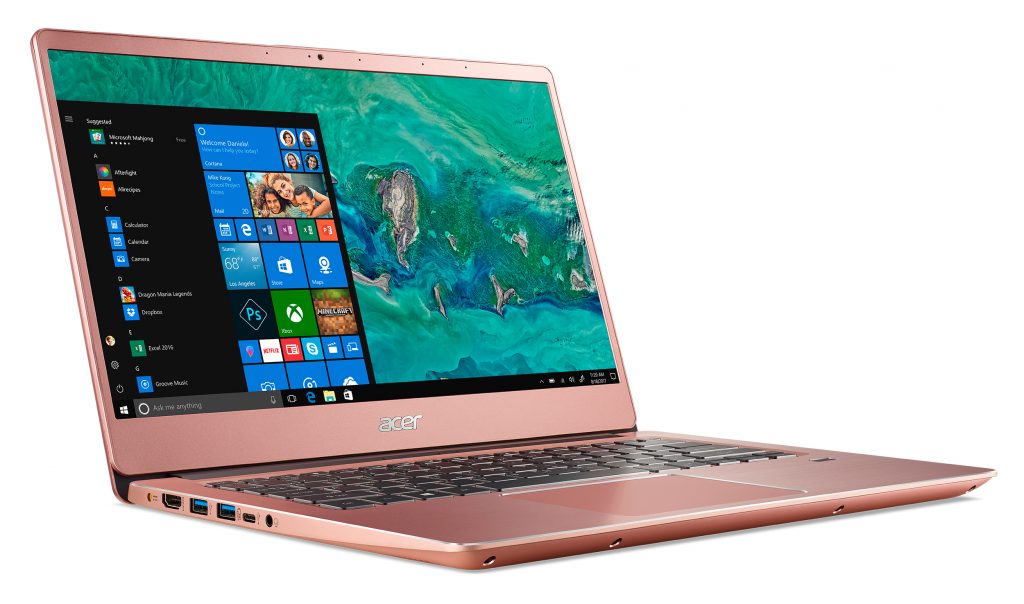 Acer Swift 3 (SF314-56G) in pink, facing right with the screen showing the Windows Start menu and an ocean background