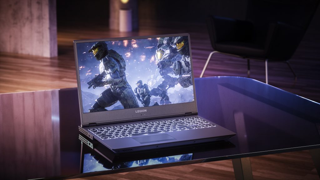 Lenovo Legion Y530 laptop on a glass desk, open to show "Halo" the game on the screen