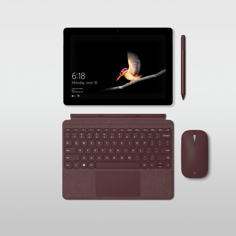 Photo of a Surface Go, separated by the screen, typepad, pen and mouse