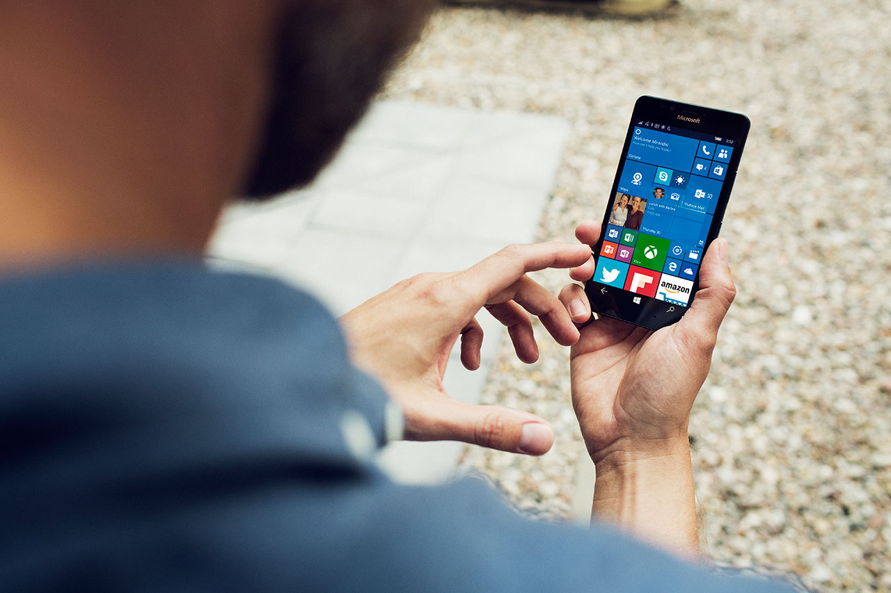 A man holding a Lumia 950.