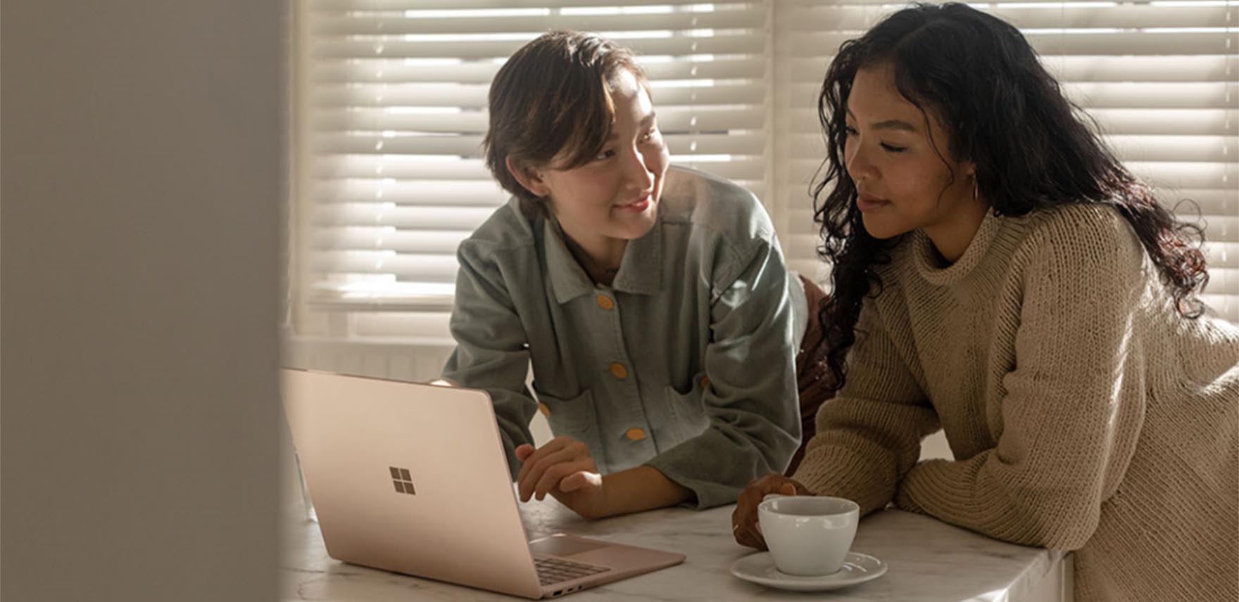 Two people working on a Surface laptop