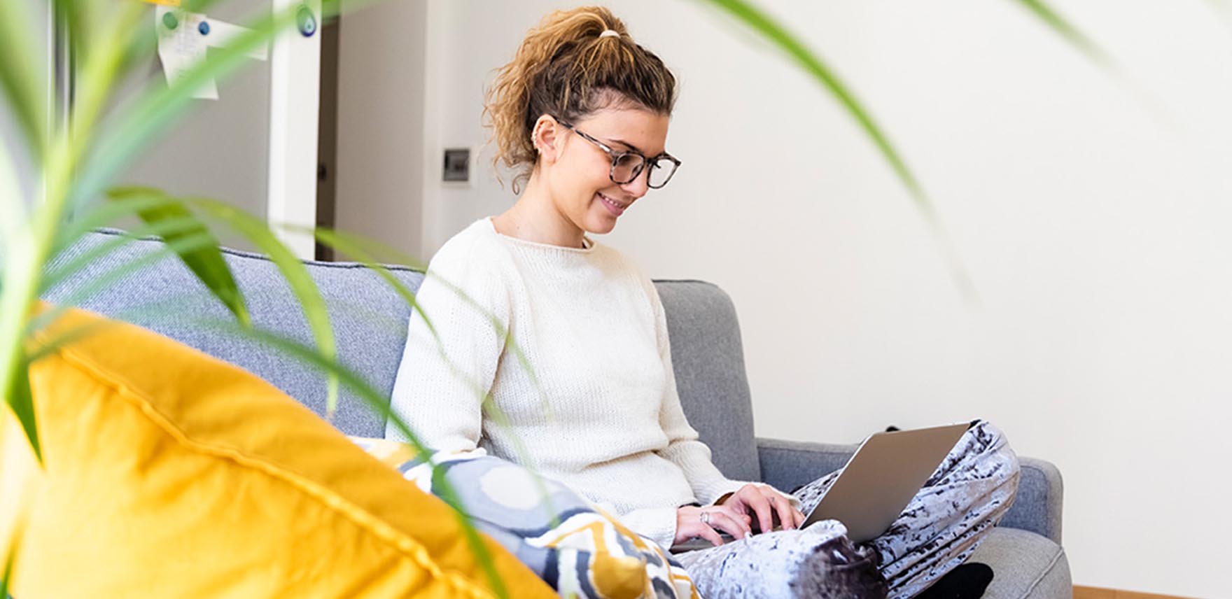 Woman smiling as she works at home on a laptop