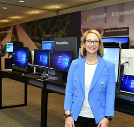 Woman stands in front of computers