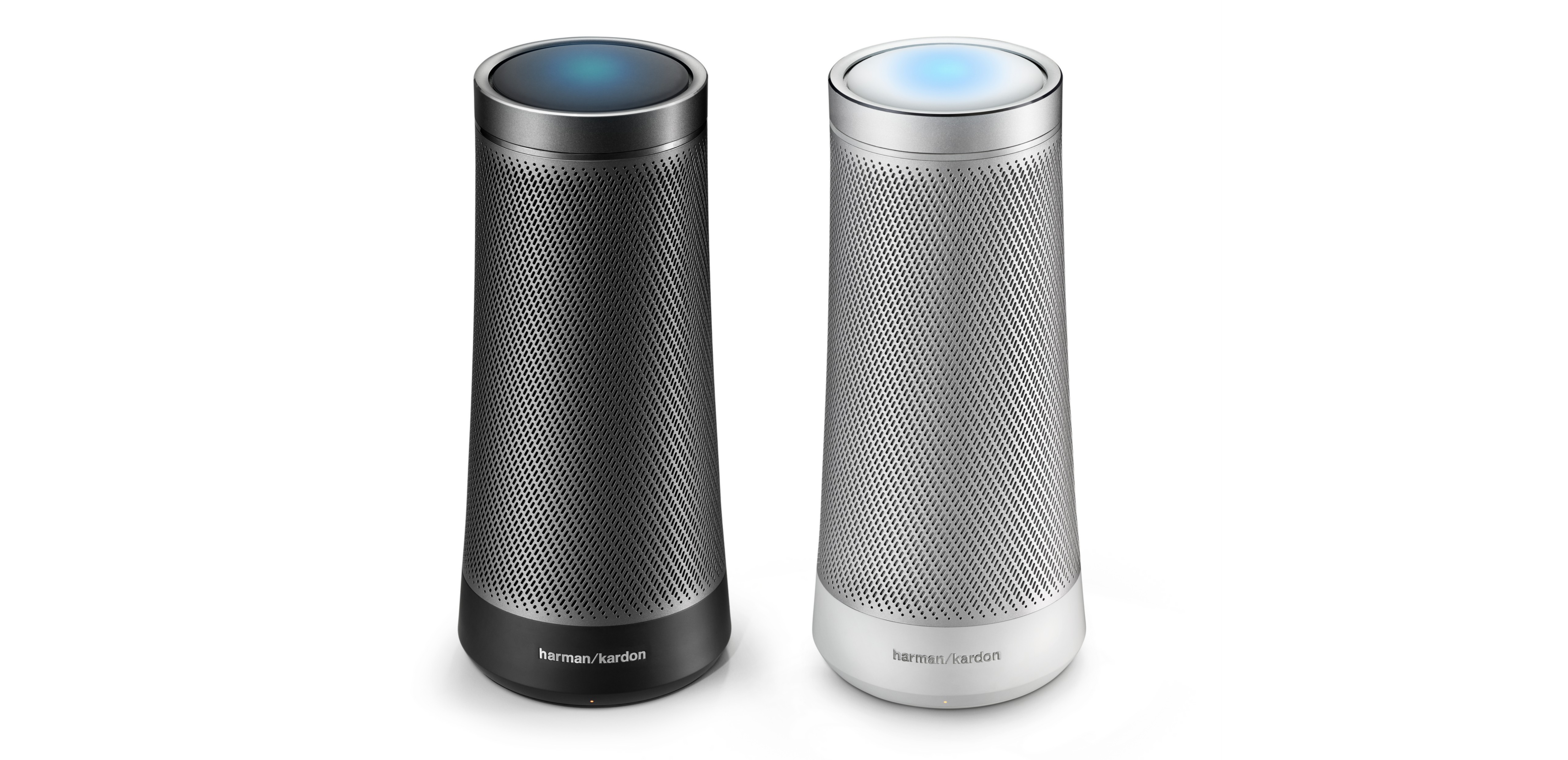 Product shot of two Harman Kardon Invoke speakers on a white background side by side, one is black in color and the other is white.