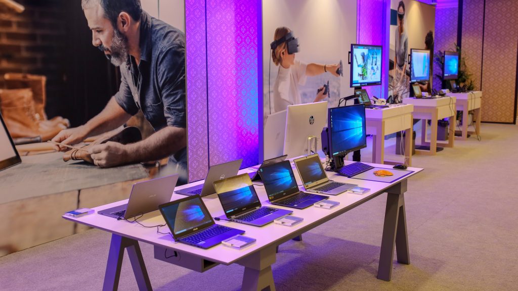 Image of Microsoft Experience Center at CES with different OEM PCs displayed on a table.