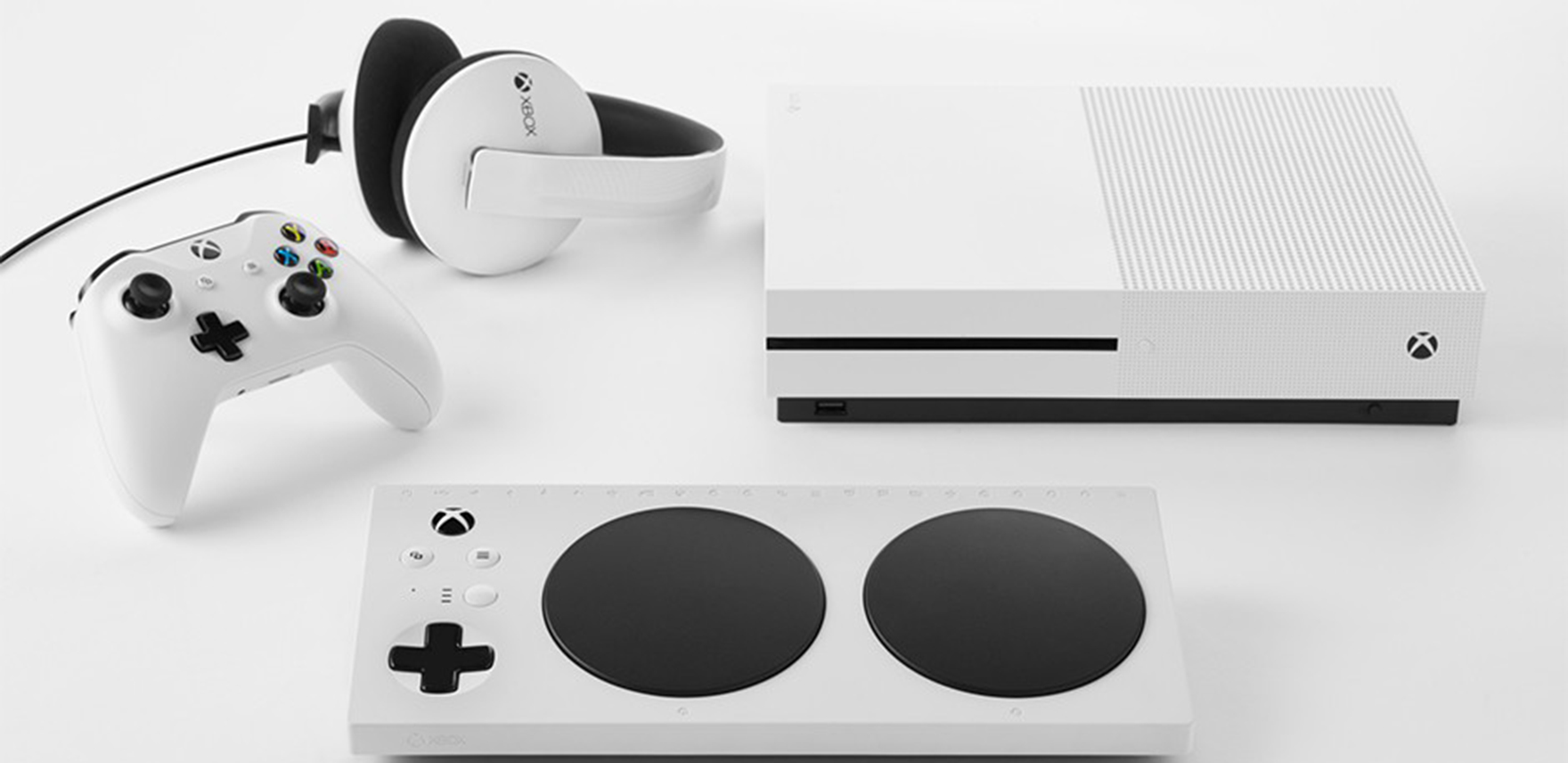 Photo of white Xbox Adaptive Controller, Xbox One X console, Xbox controller and headphones