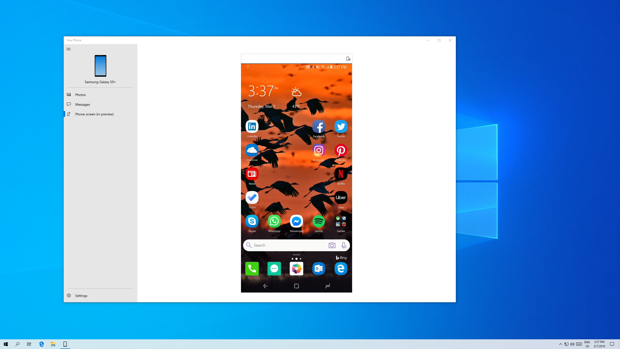 Showing Your Phone open on the desktop, with a picture of the Microsoft Launcher home screen from an android visible within the Your Phone window