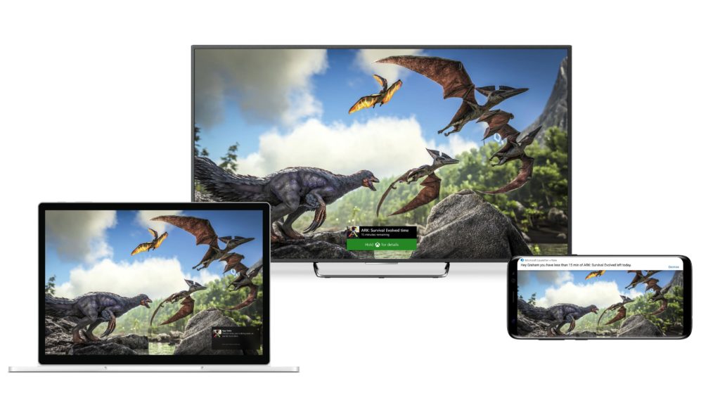 Three screens with same image -- dinosaurs -- on Windows 10 laptop, TV screen and mobile phone