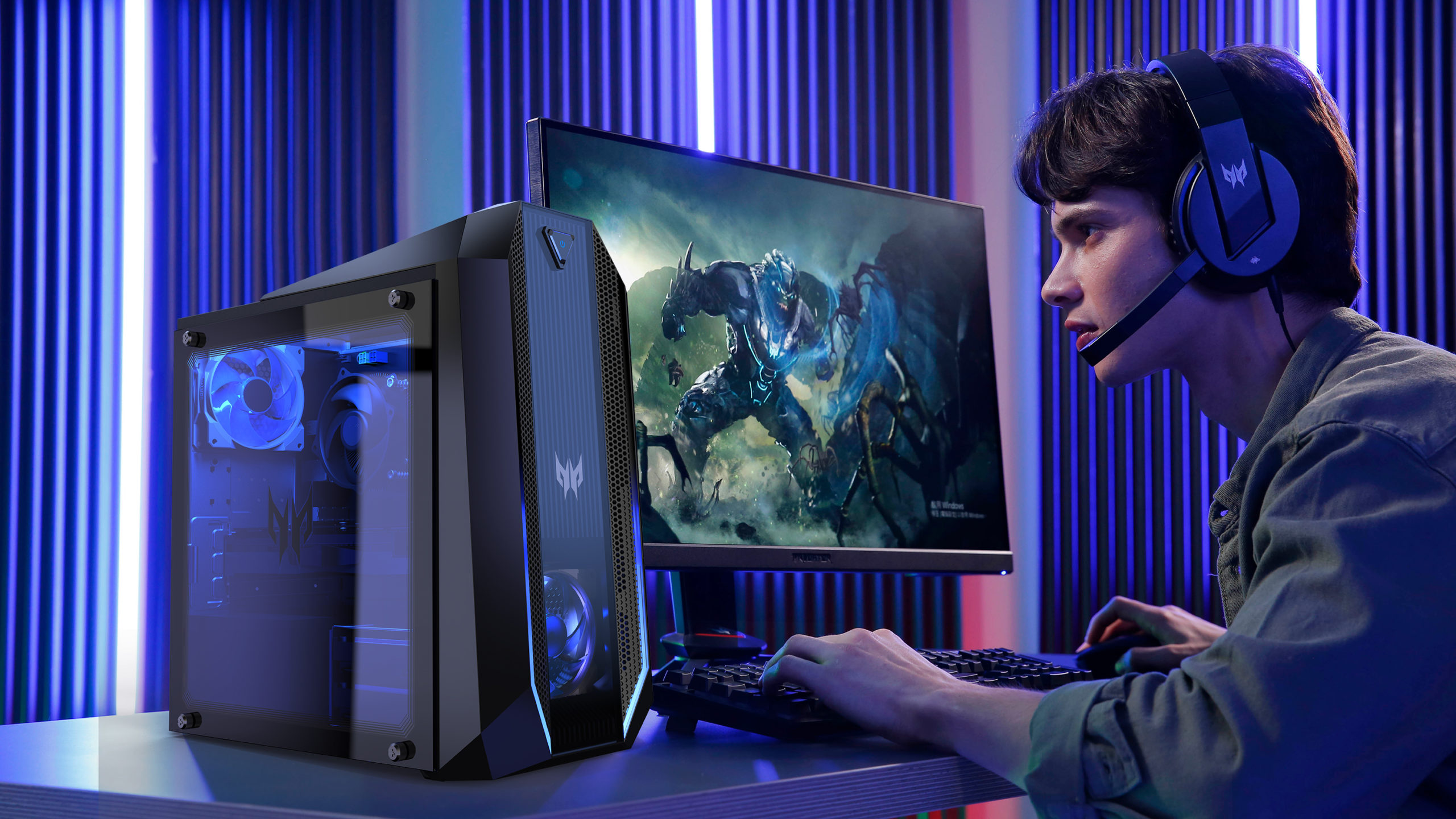 Young man playing a game on Predator Orion 3000, wearing headphones
