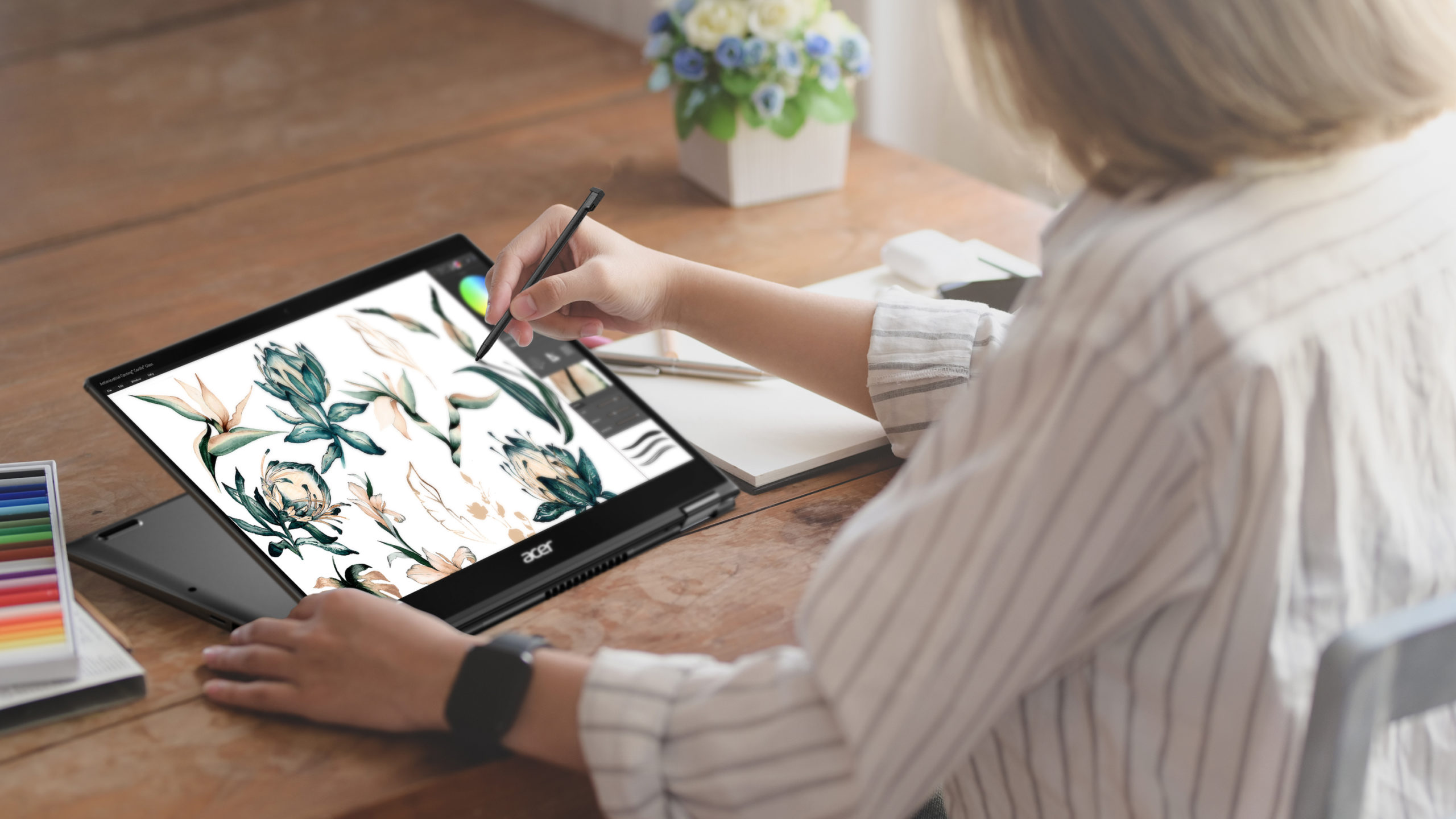 Woman working on Acer Spin 5 in tablet mode, using pen to draw on it