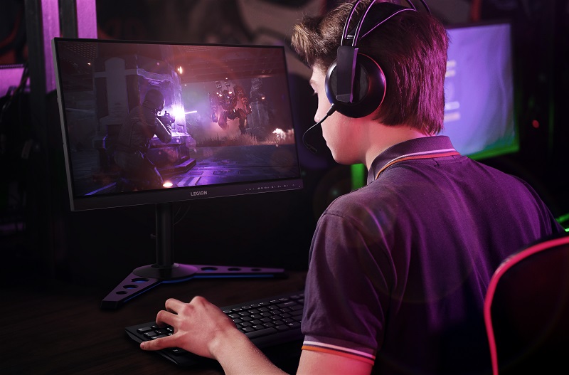 Gamer with headset playing esports in front of monitor