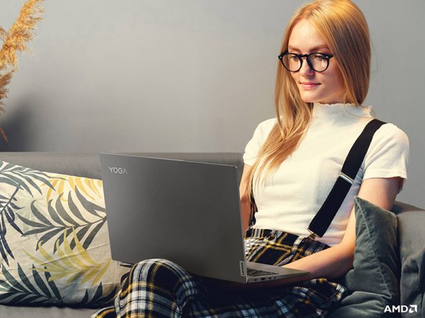 Woman sitting on a couch working on a laptop device