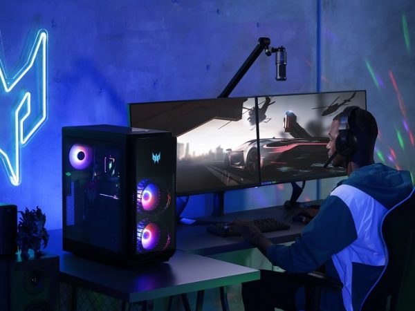 Man in a dimly lit room playing on a gaming rig