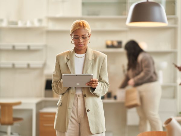 Woman in a retail business entering information into a tablet device
