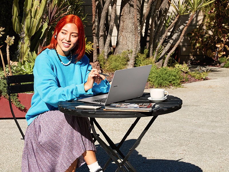 Woman sitting at a table working on a laptop