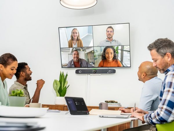 People in a conference room talking with people on the screen