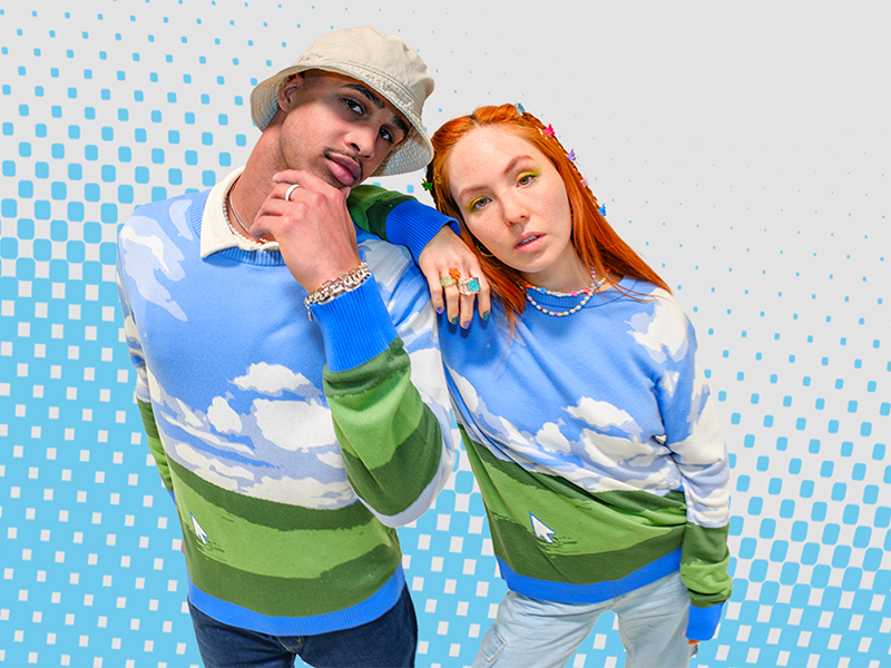 Twentysomething man and woman wearing Windows-themed sweaters