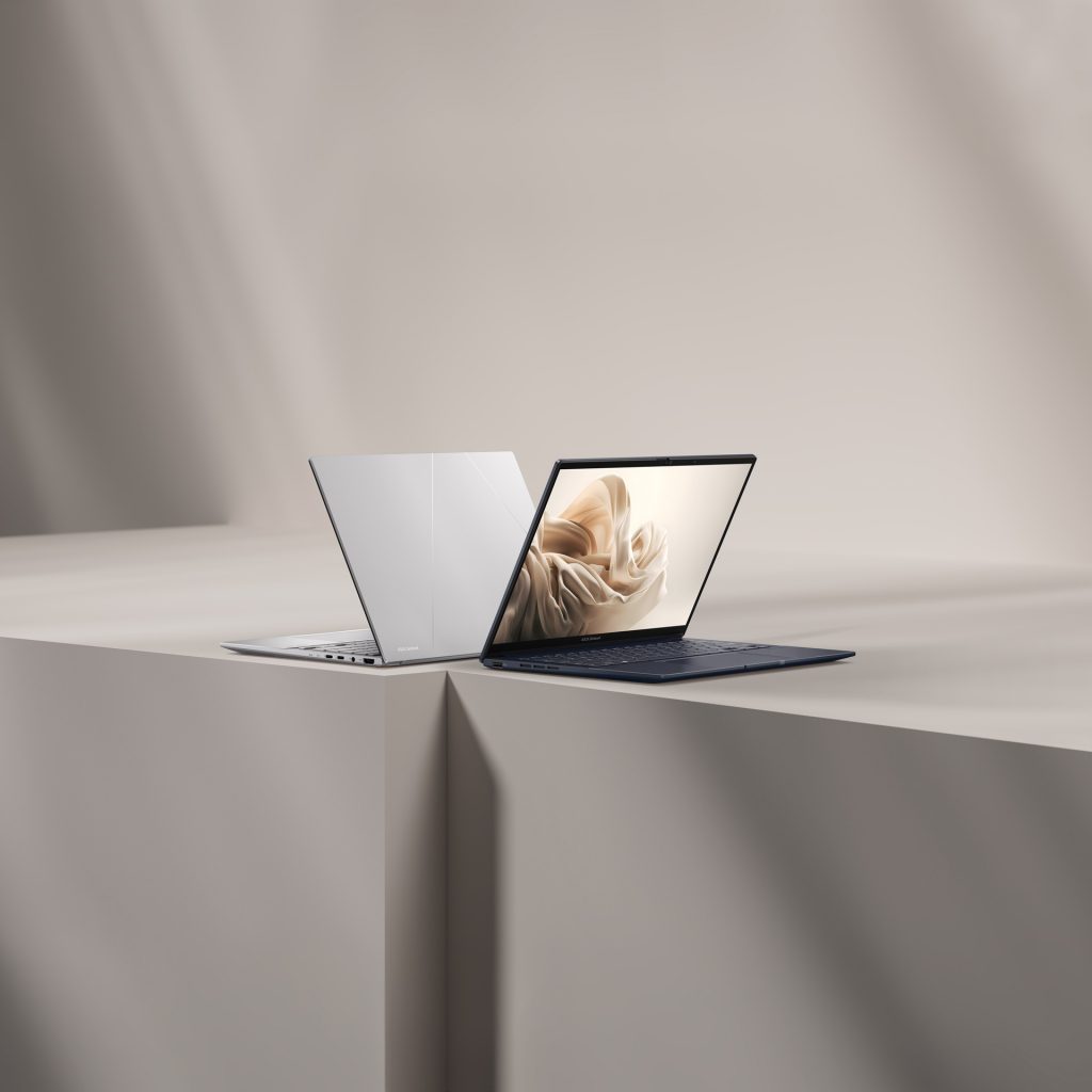 Two Zenbook 14 OLED laptops open on a landing back to back