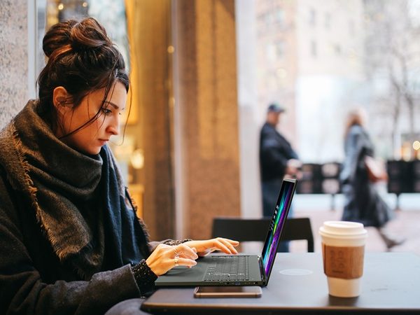Woman sitting in a cafe working on a laptop