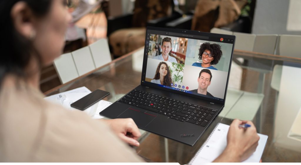 Woman looking down at 4 people on screen for a Teams video call