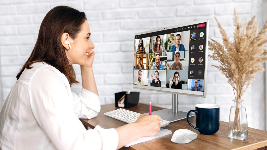 Woman smiling at monitor during video conference call