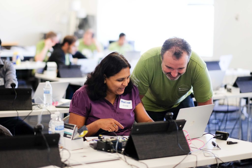 Pratima Godse shares her progress with an event staffer at the Microsoft IoT Hackathon in Houston, Texas