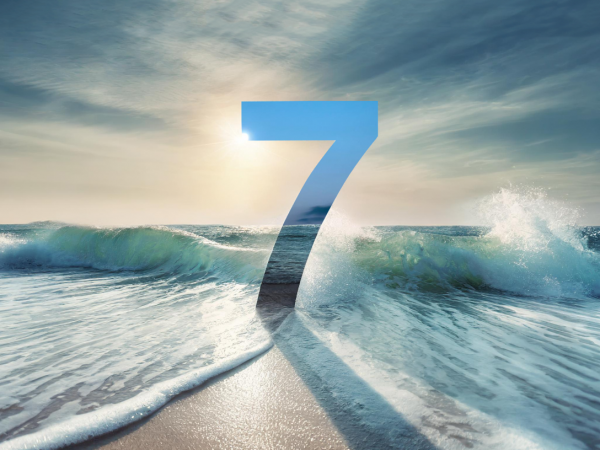 Wave crashing on the shore with the number 7 superimposed above