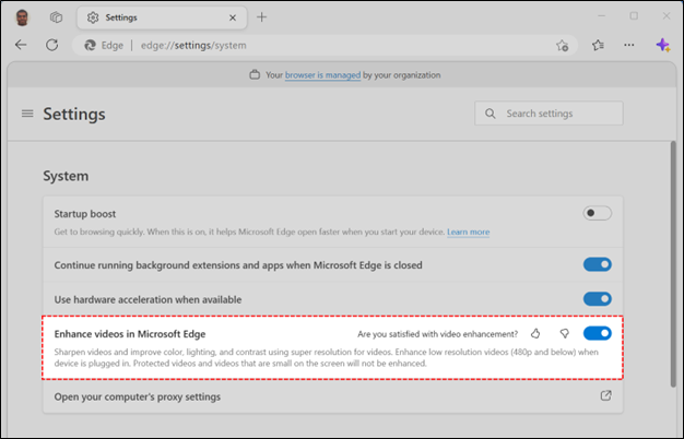 The edge://settings/system page open with the setting for "Enhance videos in Microsoft Edge" highlighted. The description reads: "Sharpen videos and improve color, lighting, and contrast using super resolution for videos. Enhance low resolution videos (480p and below) when device is plugged in. Protected videos and videos that are small on the screen will not be enhanced."