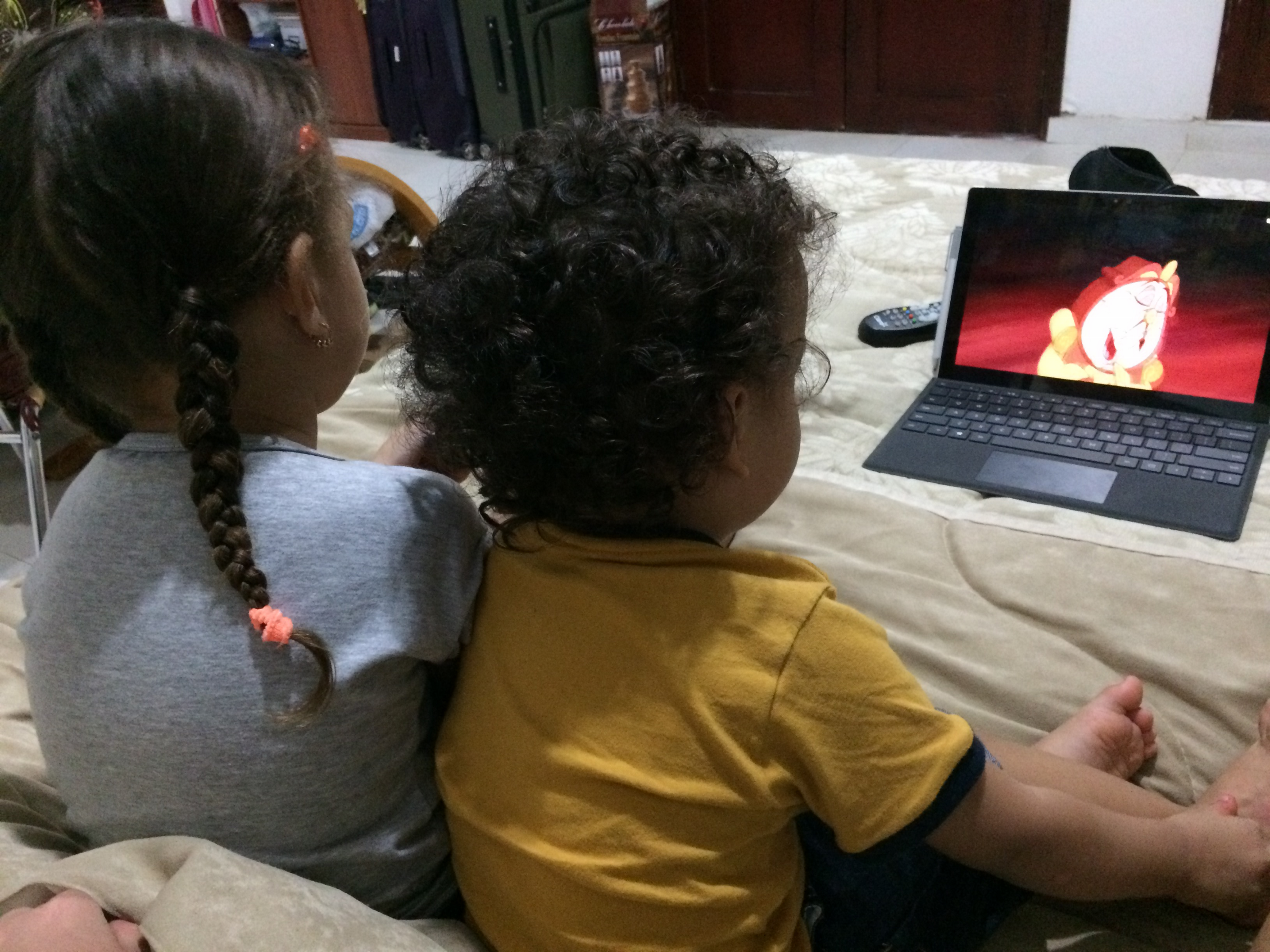 Kathy’s Goddaughter and nephew watching a movie.