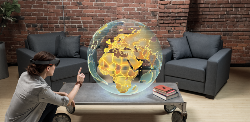 Person wearing HoloLens and pointing at a globe