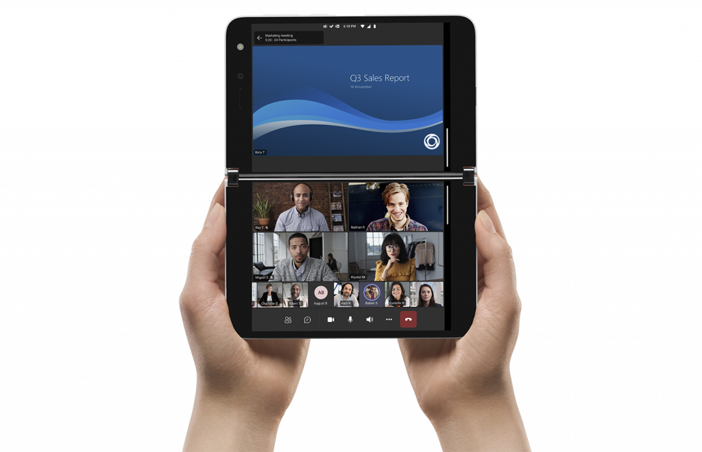 Two hands hold a Surface Duo device with a PowerPoint presentation on the top screen and a Microsoft Teams chat with participants on the bottom screen