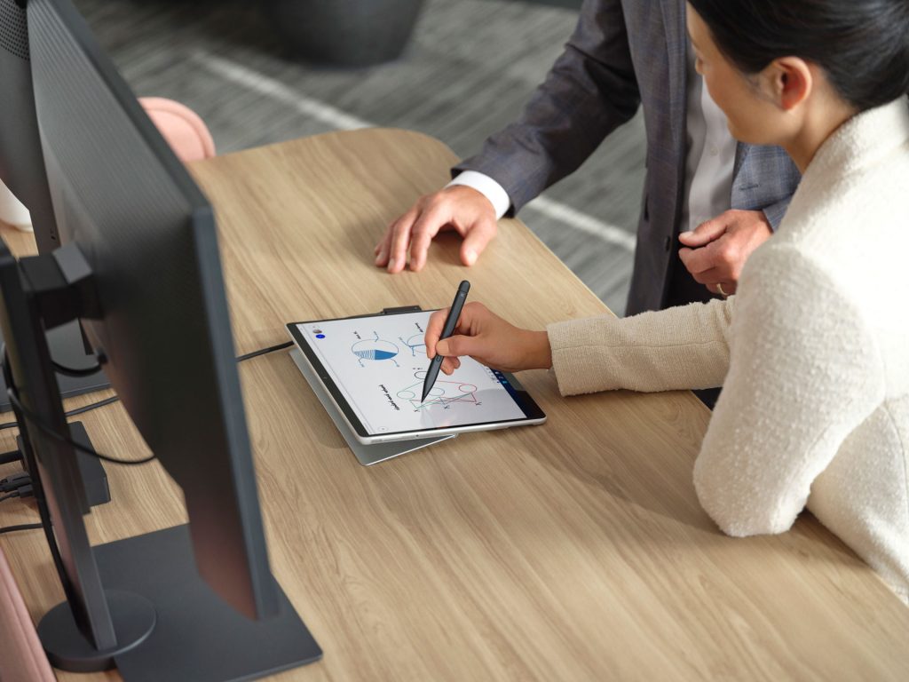 Woman using a Surface Slim Pen 2 with a Surface Pro device