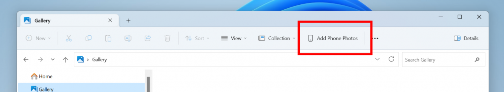 Opção Adicionar fotos do telefone na barra de comando do File Explorer.