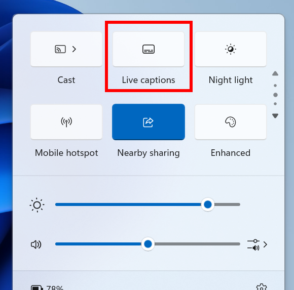 The new live captions quick setting highlighted with a red box in the quick settings flyout from the system on the taskbar.
