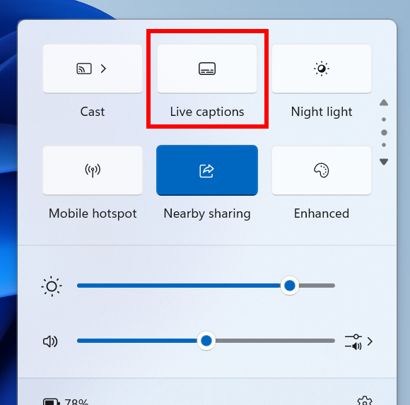The new live captions quick setting highlighted with a red box in the quick settings flyout from the system on the taskbar