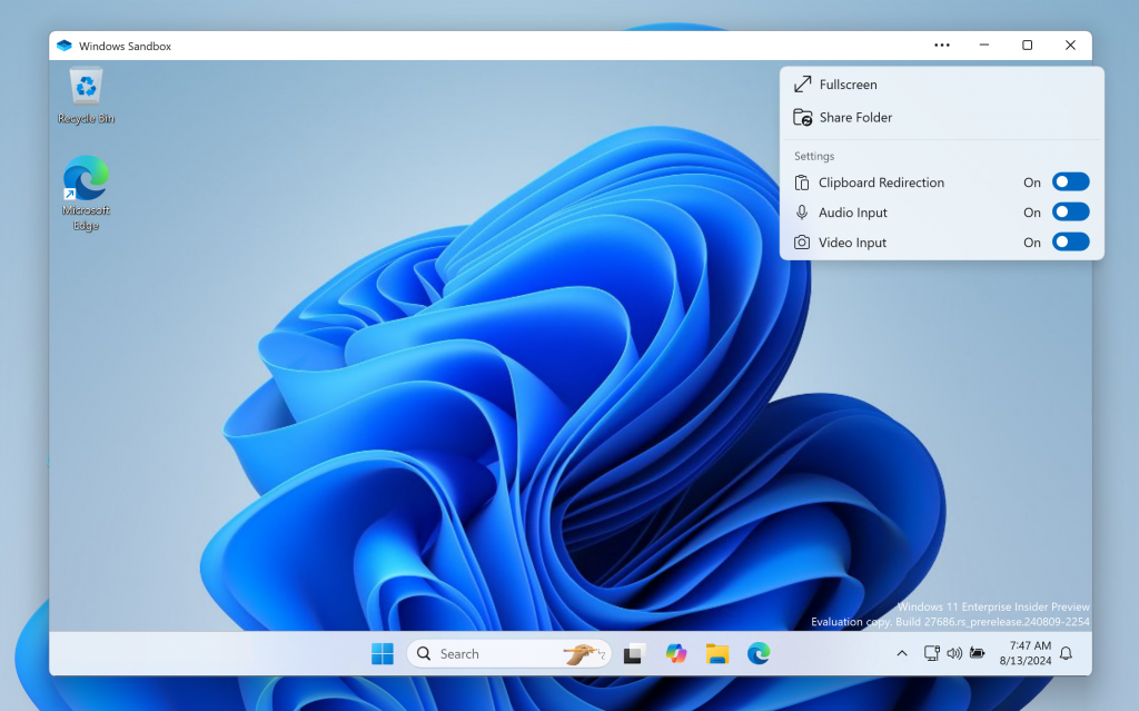 Windows Sandbox Client Preview with new dropdown showing clipboard redirection, audio/video input control, and the ability to share folders with the host